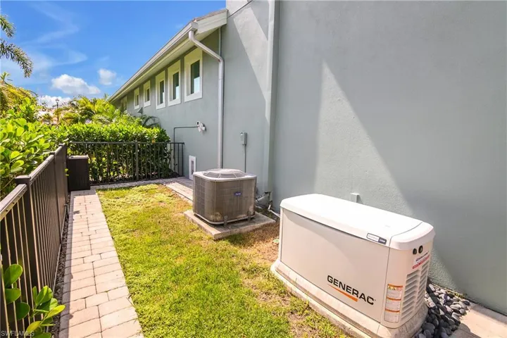 Whole house generator offers peace of mind. Note this fenced area is a perfect dog run!