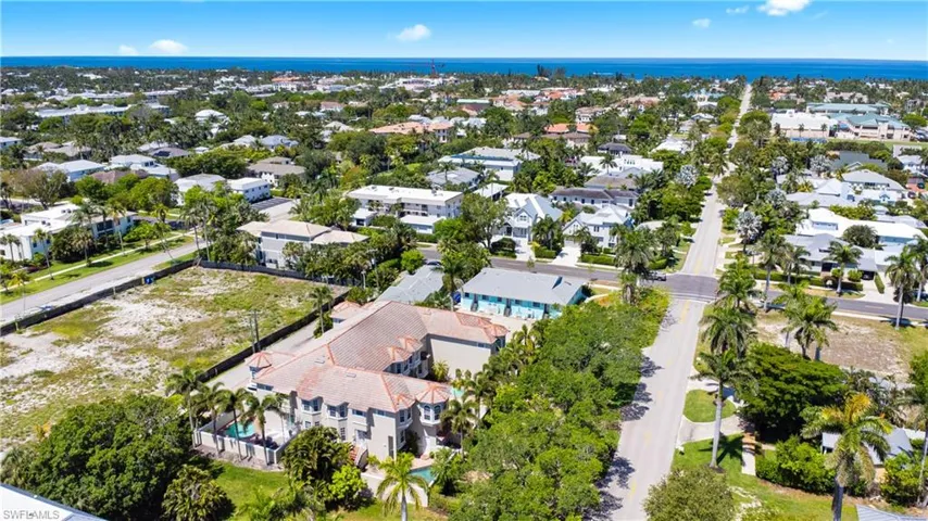 Aerial view of residential area featuring a large body of water