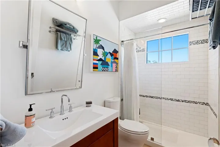 Washroom featuring washer and dryer, a barn door, light wood finished floors, and cabinet space