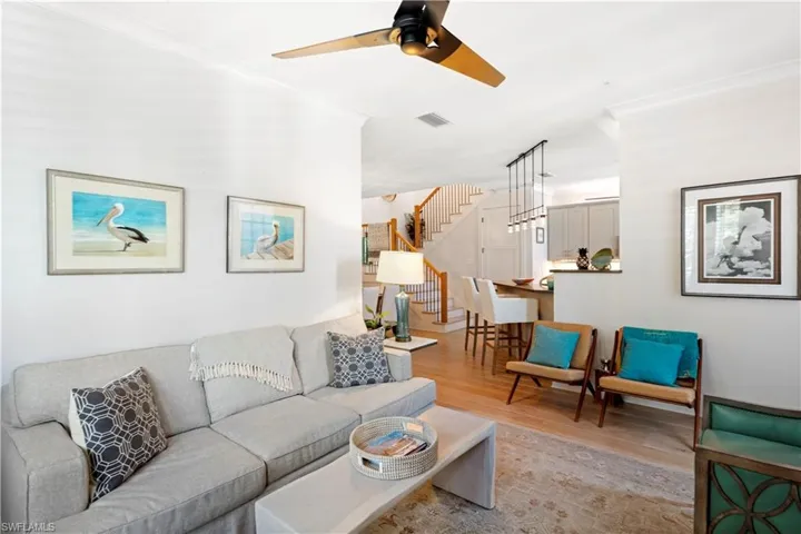 Living room featuring ceiling fan, baseboards, and wood finished floors