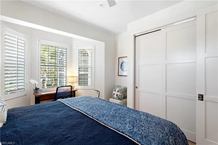 Bedroom with wood finished floors, baseboards, and a ceiling fan