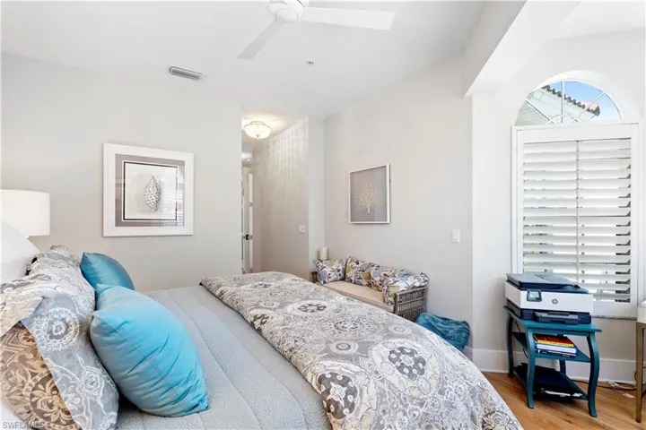 Office space with a chandelier, wood finished floors, and baseboards