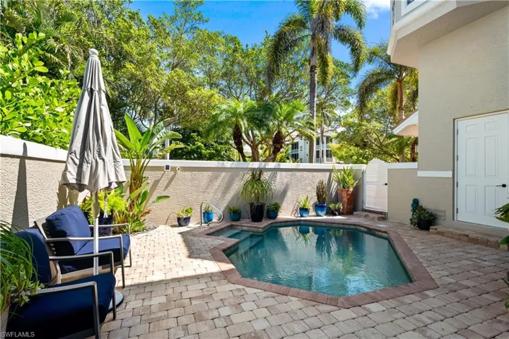 View of swimming pool with a patio area and a fenced backyard