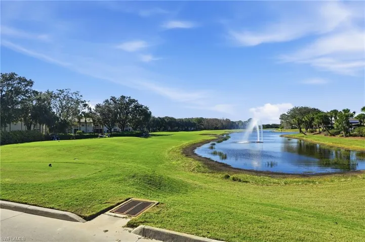 View of property's community with a water view and a yard