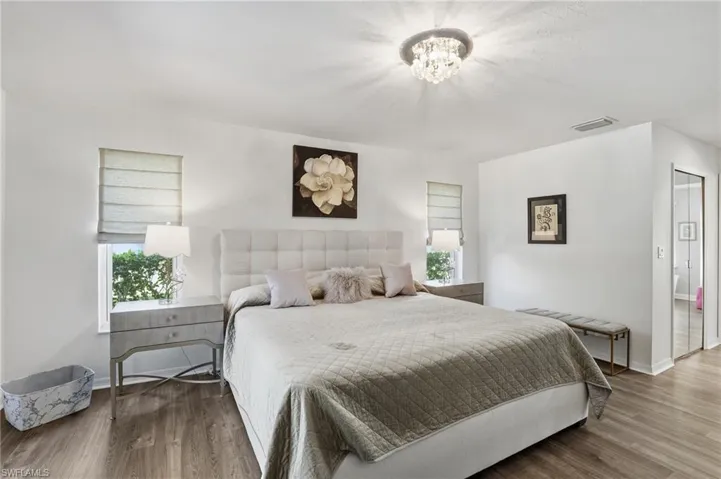 Bedroom featuring a closet, wood finished floors, and a chandelier