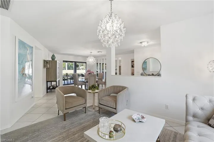 Sitting room with light tile patterned flooring tile patterned flooring and a chandelier.  This room could also be utilized as a formal dining room