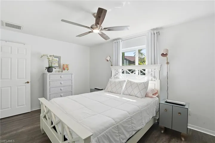 Bedroom with dark wood finished floors and a ceiling fan