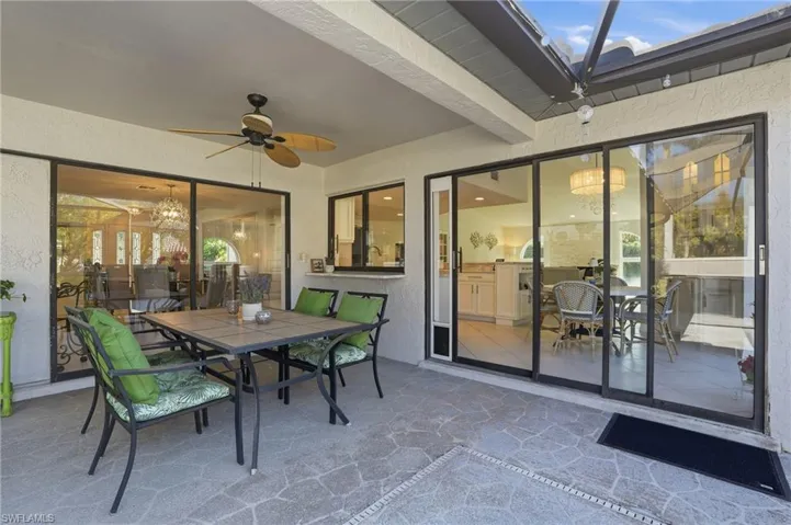 View of patio with outdoor dining space and a ceiling fan