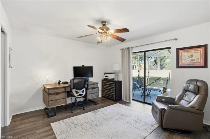 Office featuring dark wood-style floors and ceiling fan