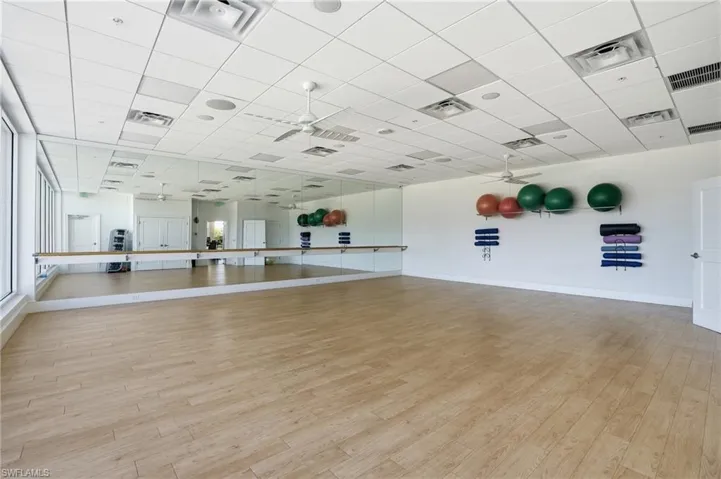 Exercise area featuring a paneled ceiling and a ceiling fan