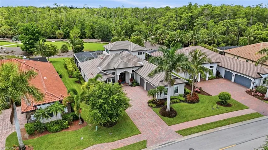 Contemporary single-story residence featuring a tile roof and light-toned exterior