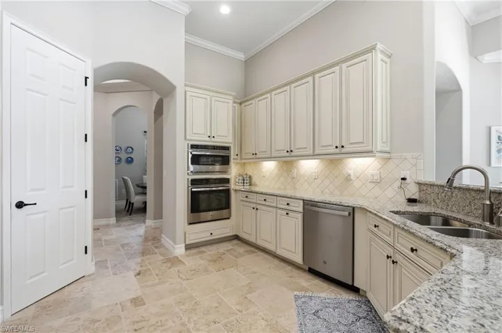 Kitchen featuring light-finish cabinetry, stainless steel appliances, granite countertops, and tile flooring