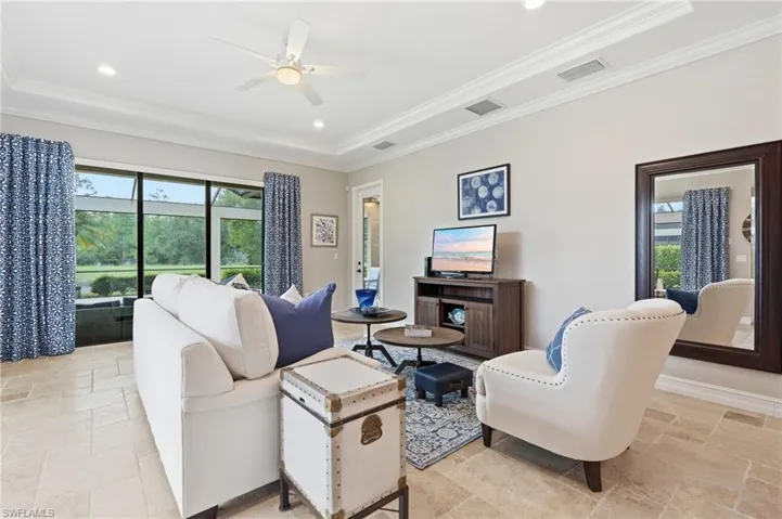 Living area with large format tile flooring, crown molding, a ceiling fan, and recessed lighting