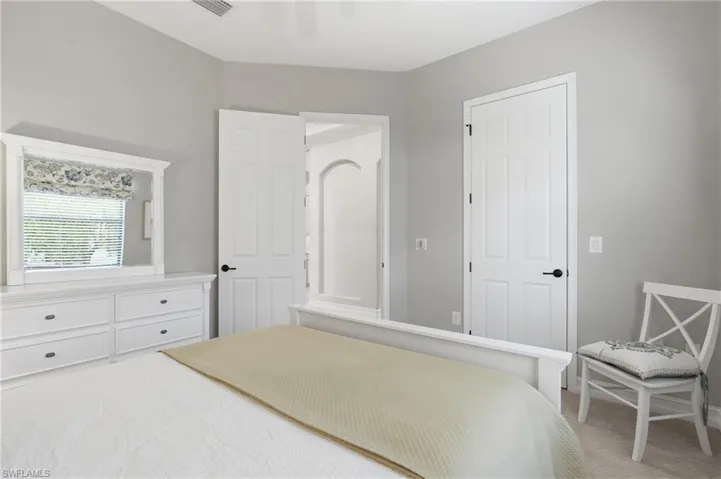 Carpeted room with light gray walls and white trim