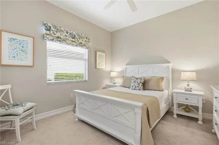 Carpeted room featuring a window with horizontal blinds, a ceiling fan, and painted walls