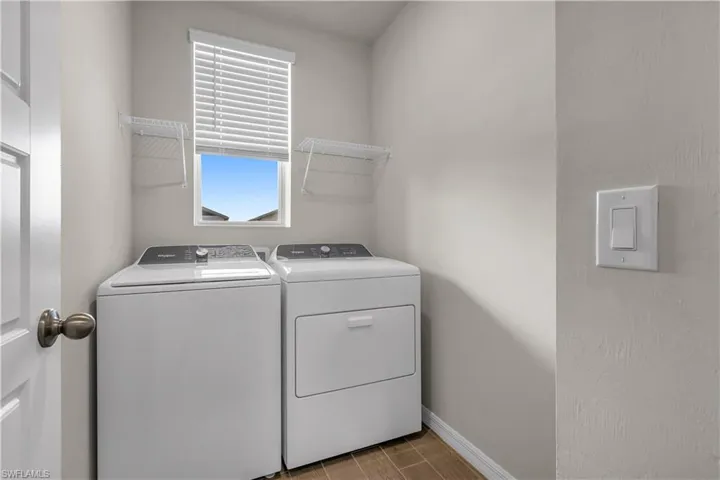 Laundry Room featuring washing machine and dryer and ceramic tiled floors