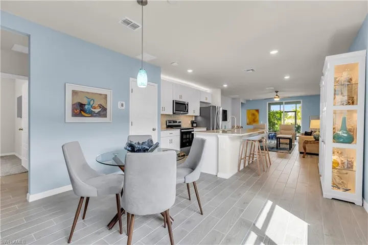 Dining room with ceramic tile floors and recessed lighting