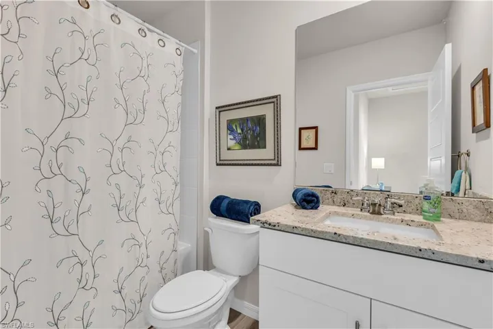 Full Bathroom with shower / tub combo and vanity. Bathroom in hallway with 2 Bedrooms.