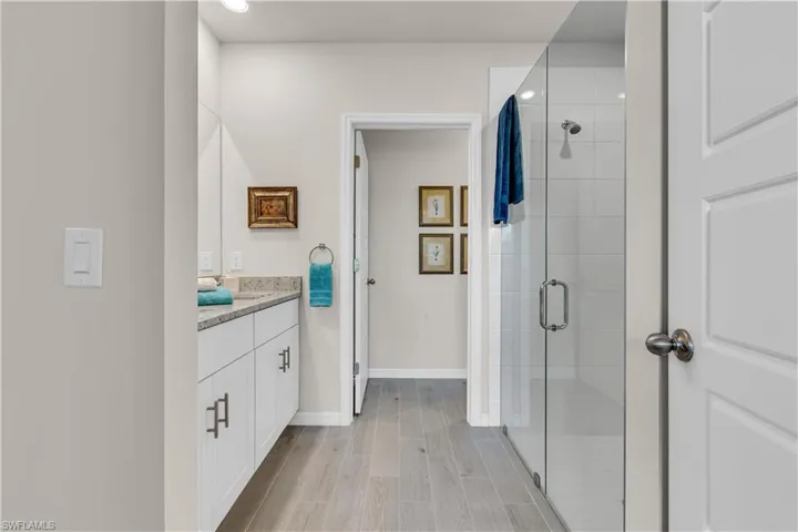 Master Full bath with a walk in framelss shower, double vanity, water closet, large built in linen closet and ceramic tile floors