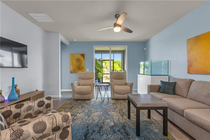 Living room with ceramic tile floors and ceiling fan