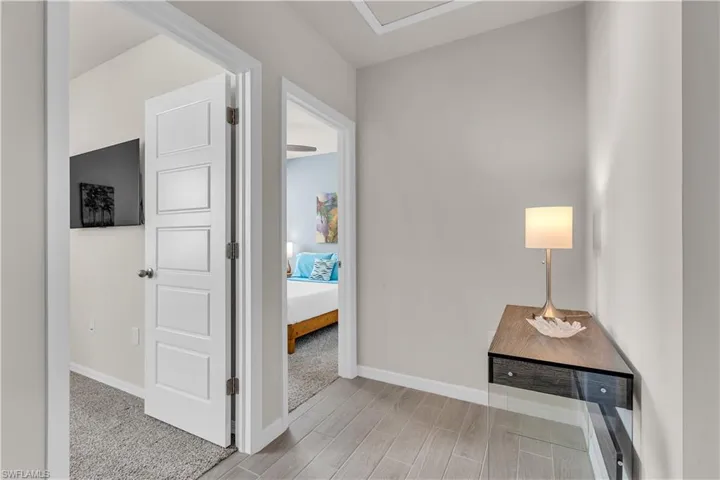 Hallway outside 2 bedrooms with baseboards and Ceramic tiled floors