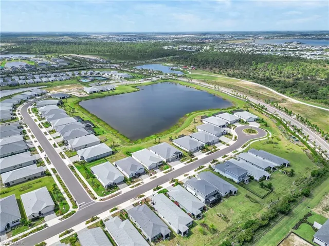 Aerial view of the Street home sits on and area with a nearby body of water