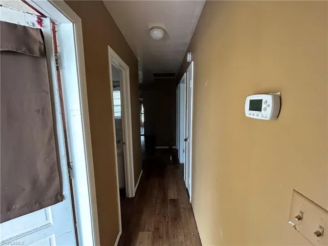 Corridor with wood finished floors and baseboards