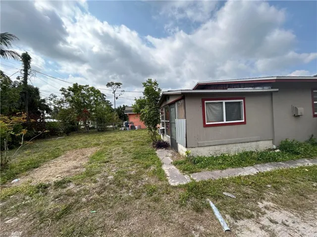 View of side of property with a lawn