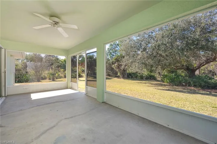 Unfurnished sunroom featuring ceiling fan and plenty of natural light