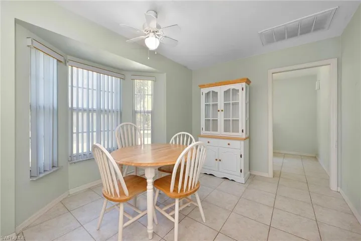 Dining room with ceiling fan and light tile patterned floors
