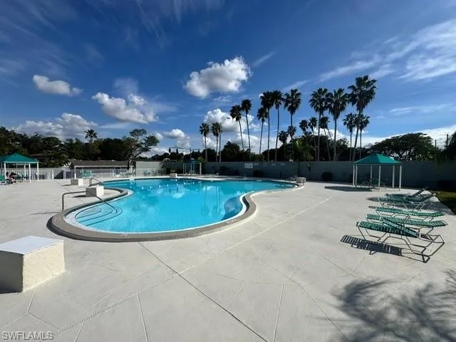 Community pool featuring a patio