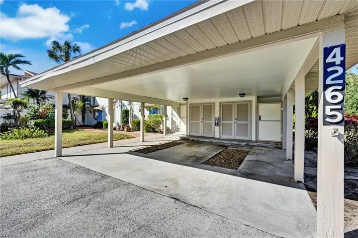 View of car parking featuring mail area and an attached carport