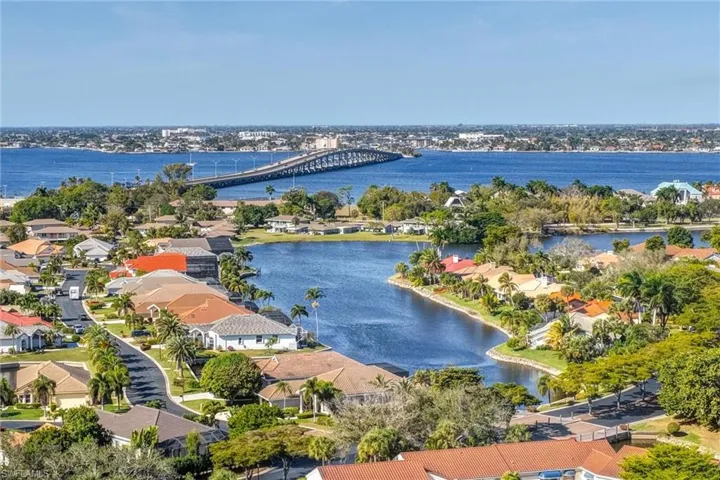 Aerial view of residential area with a notable bridge and a nearby body of water