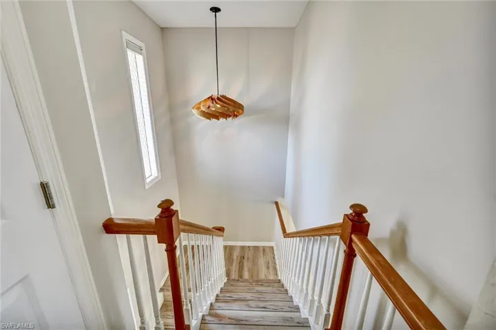 Stairs featuring hardwood / wood-style flooring