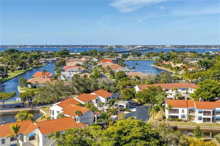 Aerial view of residential area with a notable bridge and a large body of water