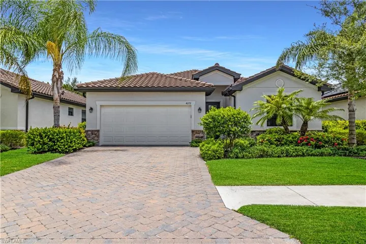 Mediterranean / spanish-style house featuring a garage and a front yard