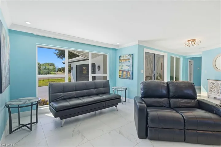 Living room is spacious and opens up to a secondary living space with wall of sliders and the most incredible views.  Electric fireplace and ceiling wood trim add to the ambience of this amazing home!