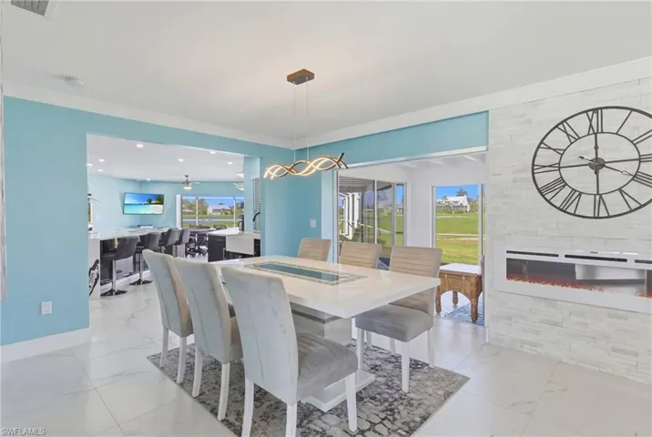 View of the dining room with extended living space, fireplace and crown molding.  A really fun and flexible floor plan that can be arranged numerous ways!