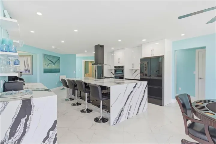 HUGE island is the nucleus of the kitchen with enough room for 4 bar stools.  Under island storage as well!