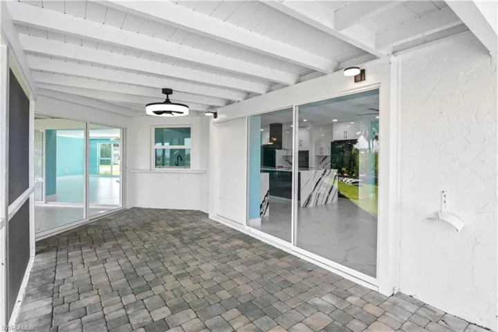 View of swimming pool with a lawn, glass enclosure, and a patio with golf views!