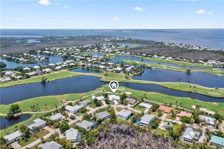 LOCATION LOCATION LOCATION!  Beautiful aerial view of the home and the surrounding golf course and in the distance the blue waters of the Gulf of Mexico!
