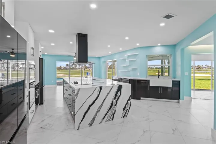 Sprawling kitchen with farmhouse sink and more of the wall of windows to maximize the views!
