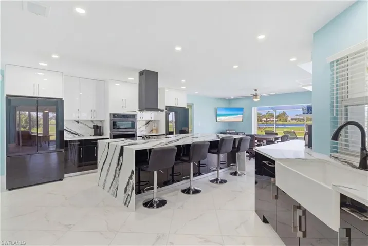 Unbelievable kitchen that is a statement not only in aesthetics but also in functionality!  TONS of room on oversized kitchen island, multiple prep spaces and TWO refrigerators!