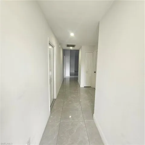 Hall featuring baseboards and recessed lighting