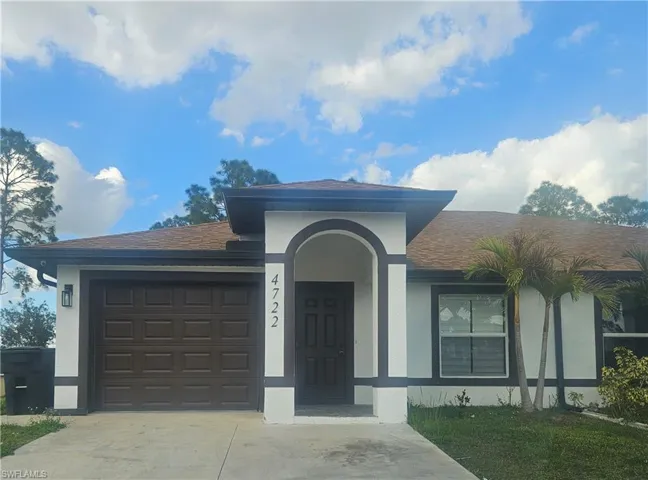 Ranch-style home featuring an attached garage, concrete driveway, stucco siding, and a shingled roof