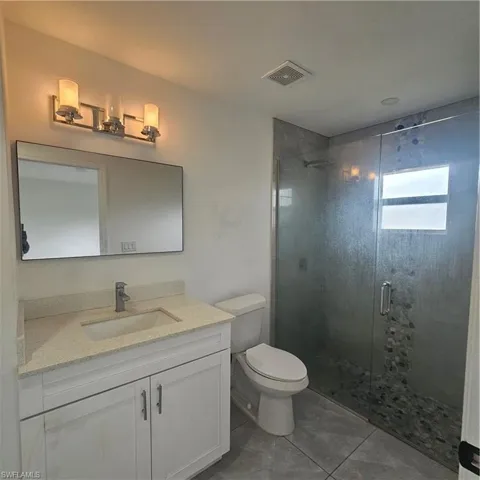 Full bathroom featuring vanity and a stall shower