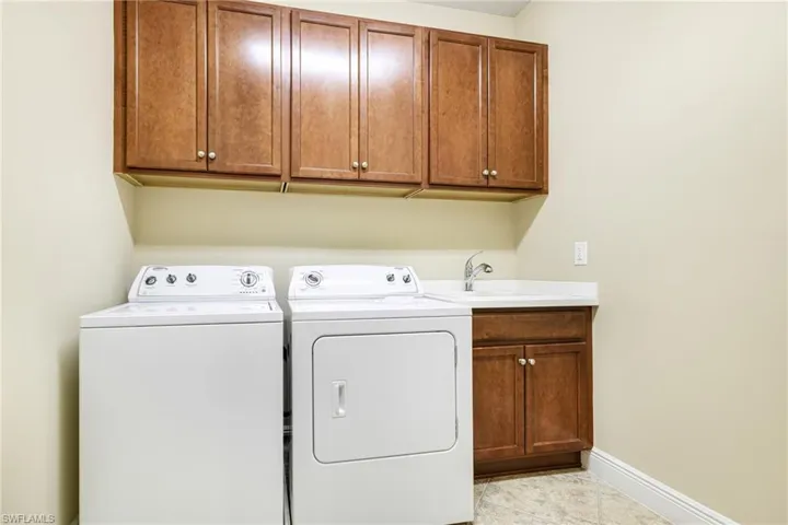With cabinets and utility sink