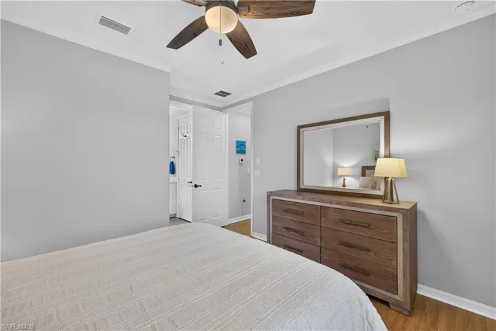 Crown molding, wood-finish laminate flooring, and attached bathroom