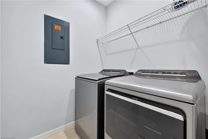 Laundry room with new washer and dryer and tile flooring.