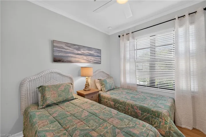 Light gray walls with white crown molding, a window with blinds, curtains and a ceiling fan